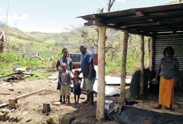 A Fijian family builds a house.