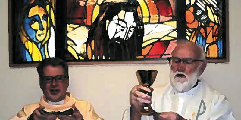 Columban Frs. Barry Cairns (right) and Leo Schumaker (left) in front of the window