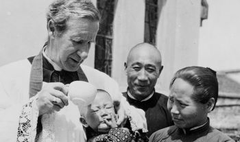 Bishop Edward Galvin baptizing a baby